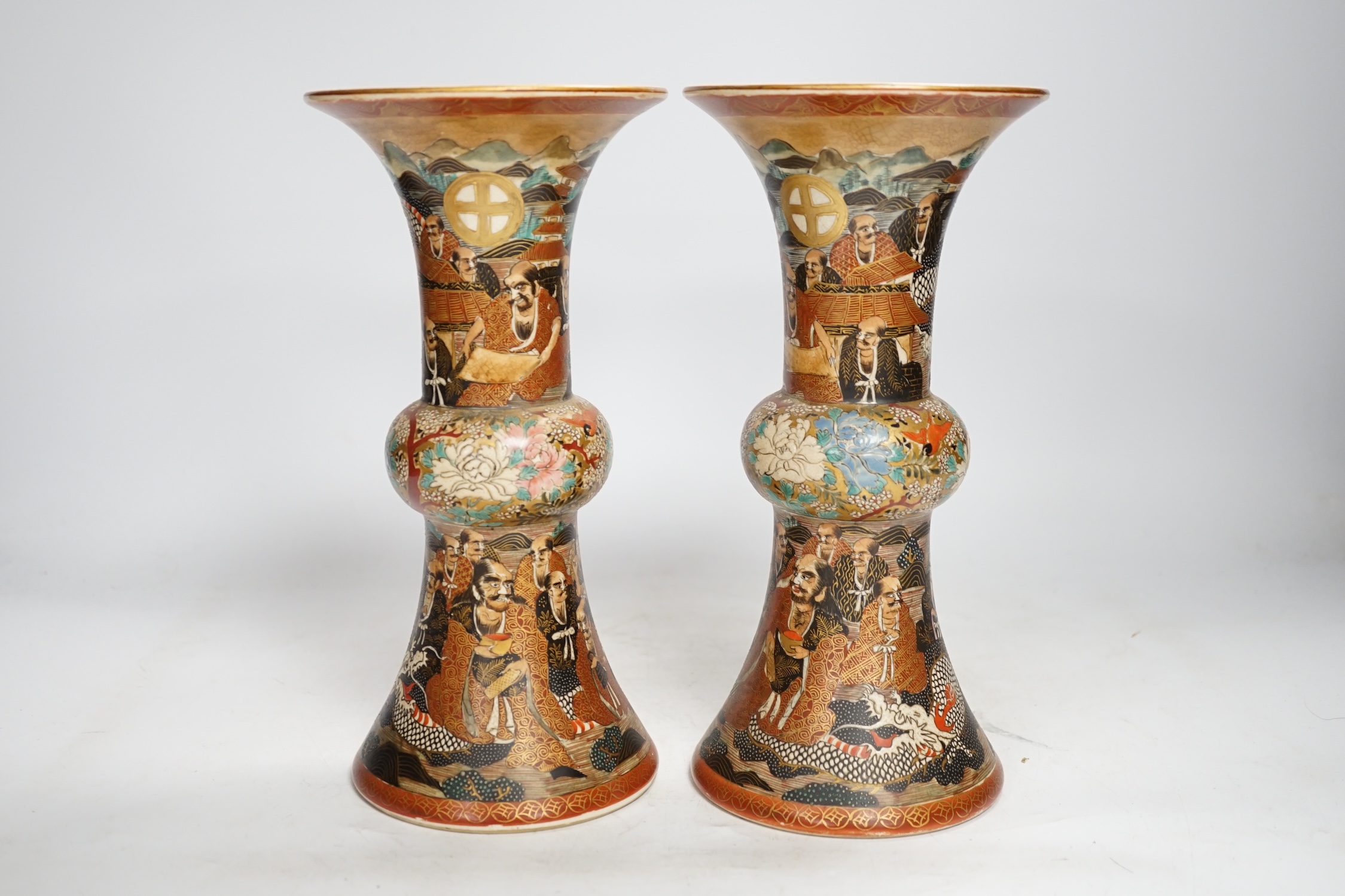 A pair of Japanese satsuma pottery 'rakan' vases, Meiji period, 24.5cm high (one a.f.). Condition - fair to good